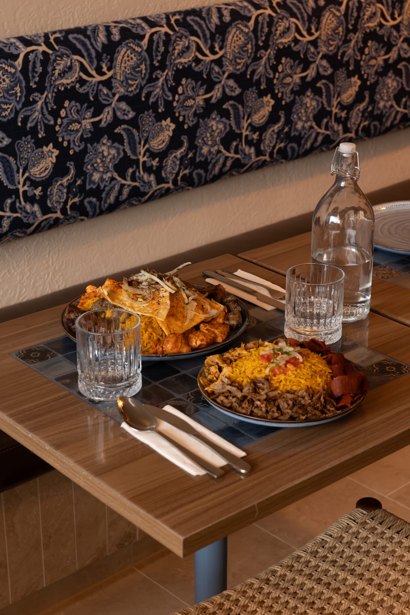 A spread of Middle Eastern plates on the blue-tiled table